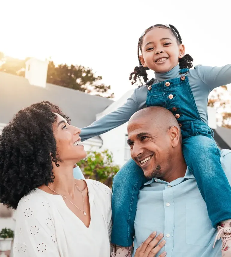 Happy family playing outdoors, parents with child in nature
